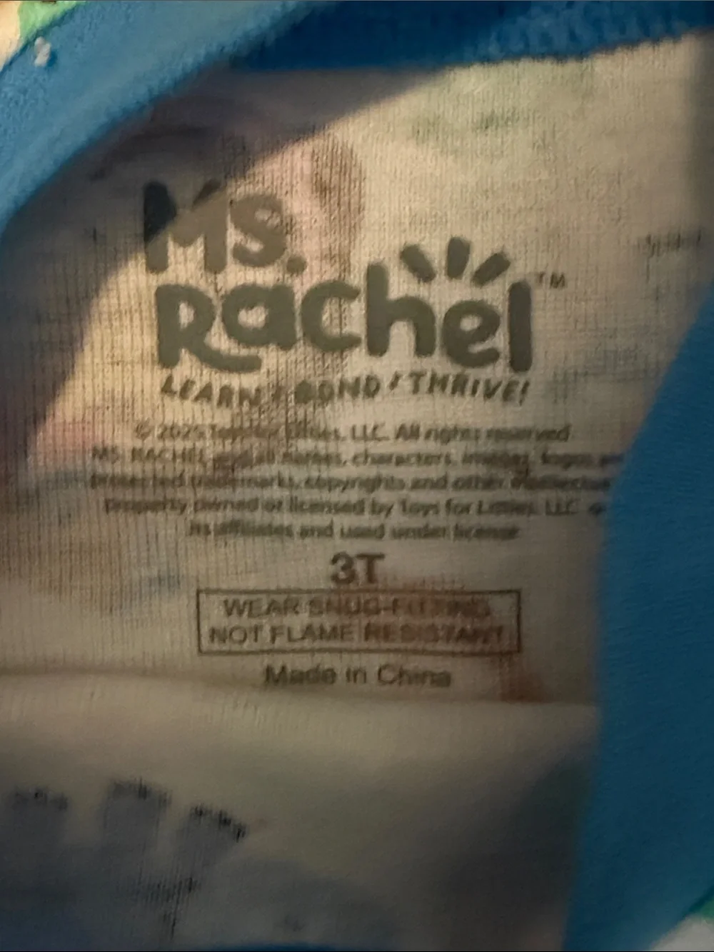 Ms Rachel Kids White Pajama Set with Blue, Orange, Green, and Purple Dinosaurs